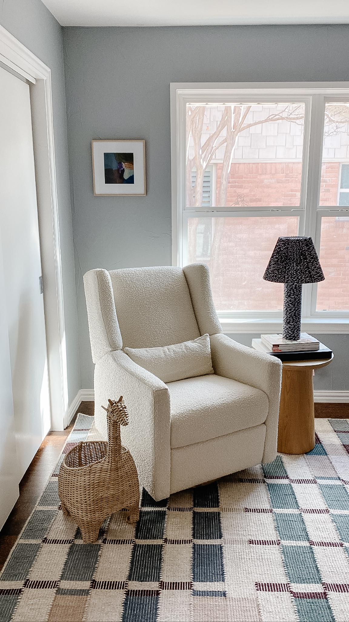 Glider in neutral nursery with modern graphics