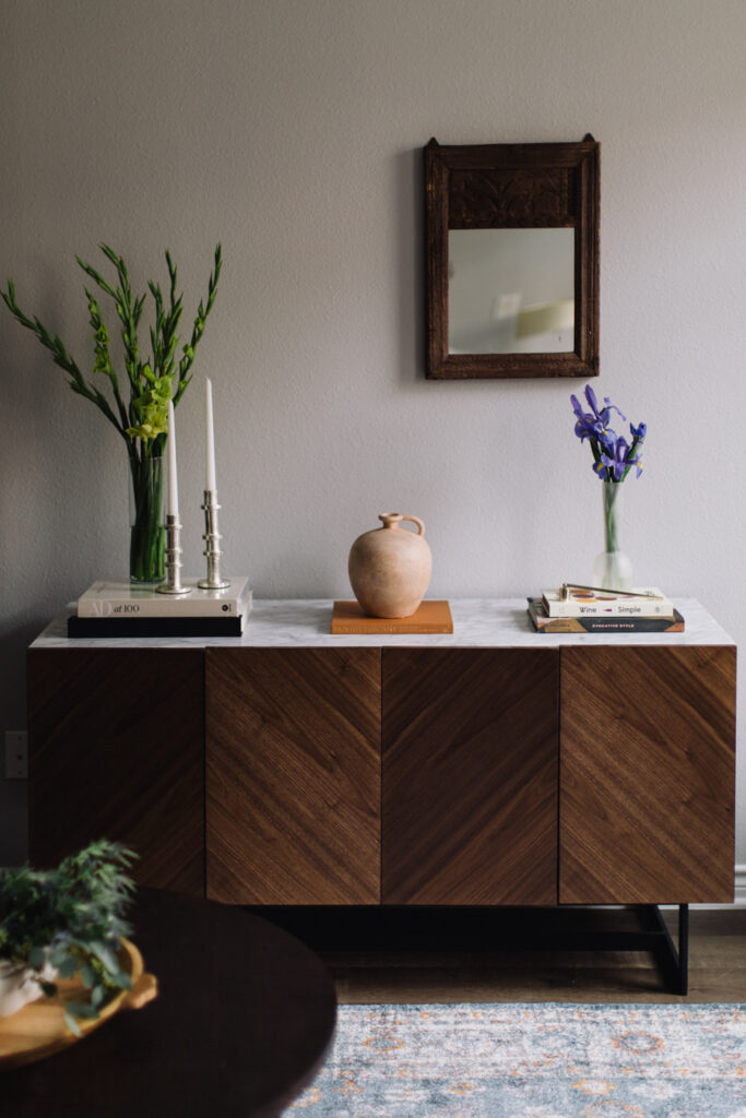 Console table with marble top and asymmetrical decor