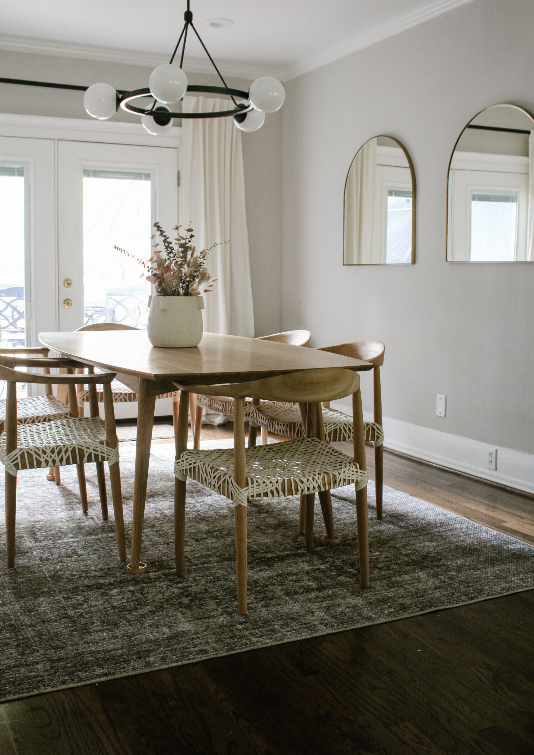 Dining room with wooden dining table and modern light fixture